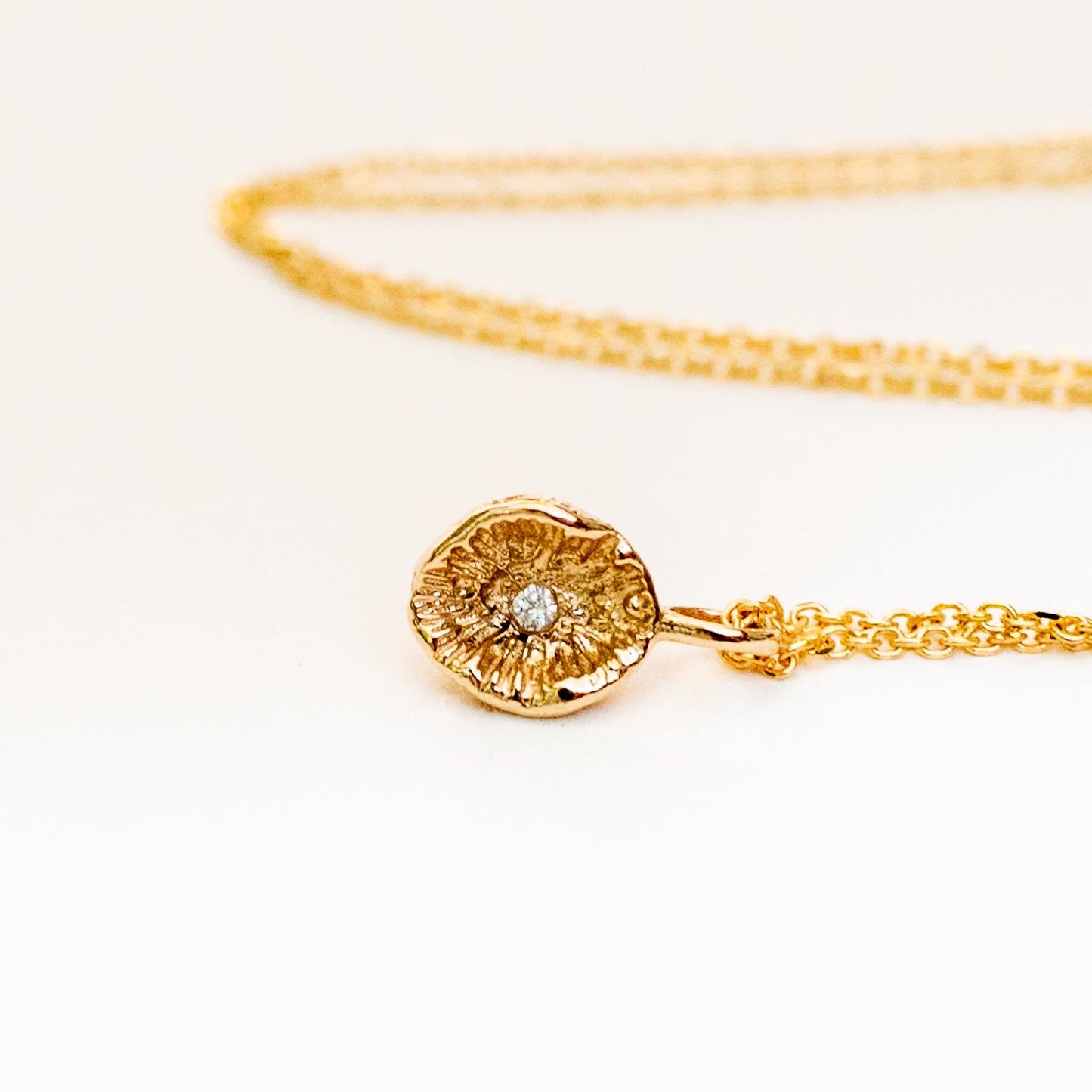 Detailed view of coral chamber-inspired pendant design with diamond