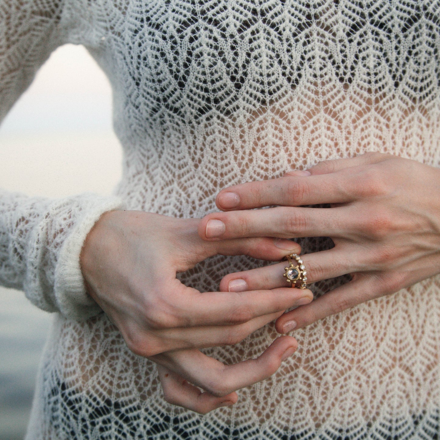 Model wearing 14K gold natural diamond eternity band on hand