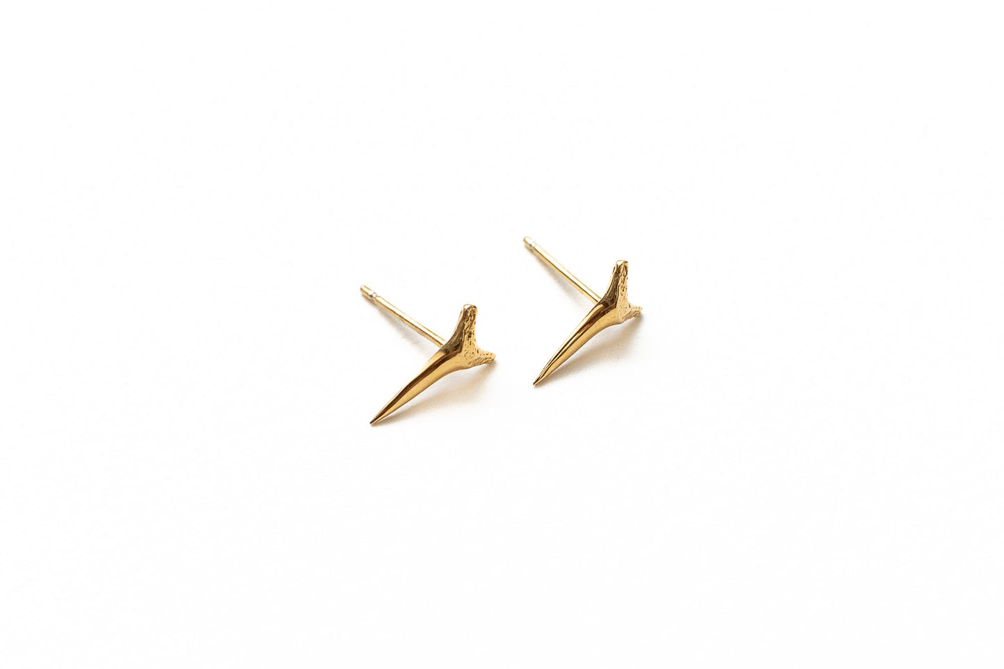 Close-up detail of gold apex stud showing high-polish vermeil finish