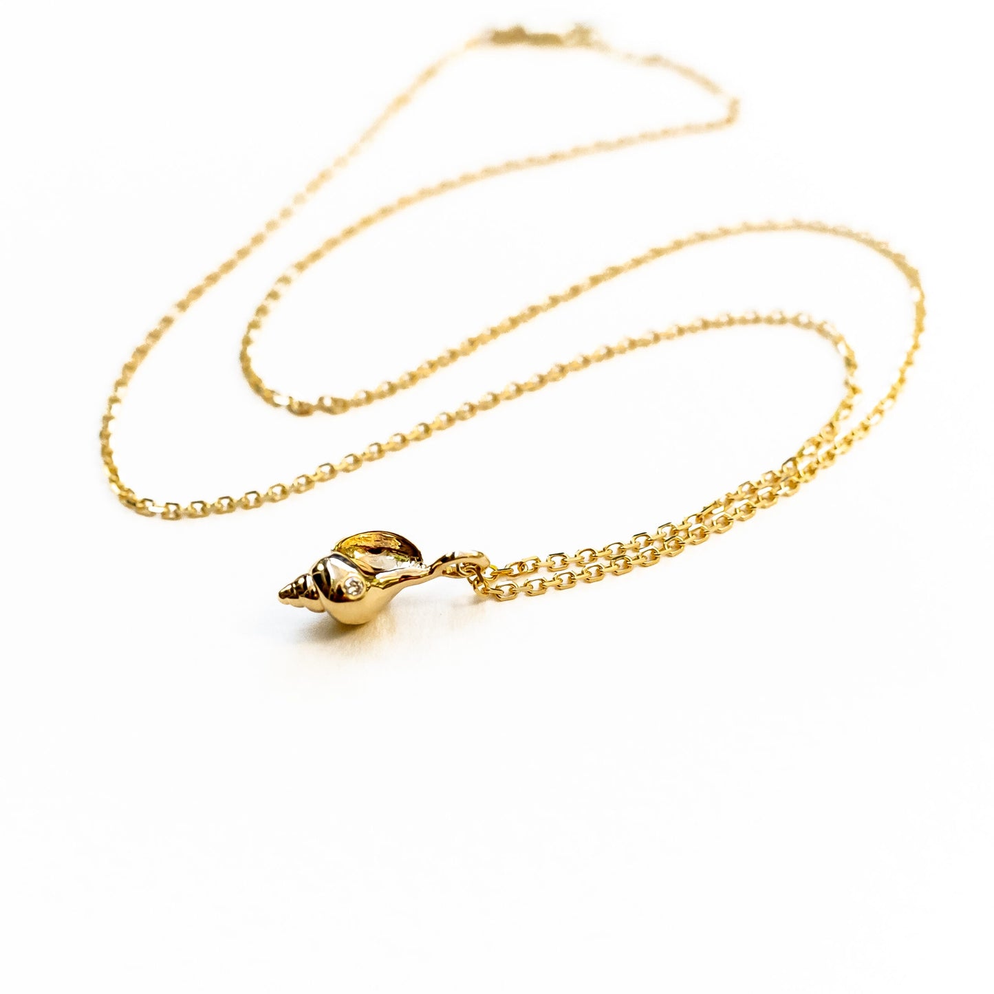 Model wearing tulip shell pendant necklace, demonstrating how jewelry hangs on body