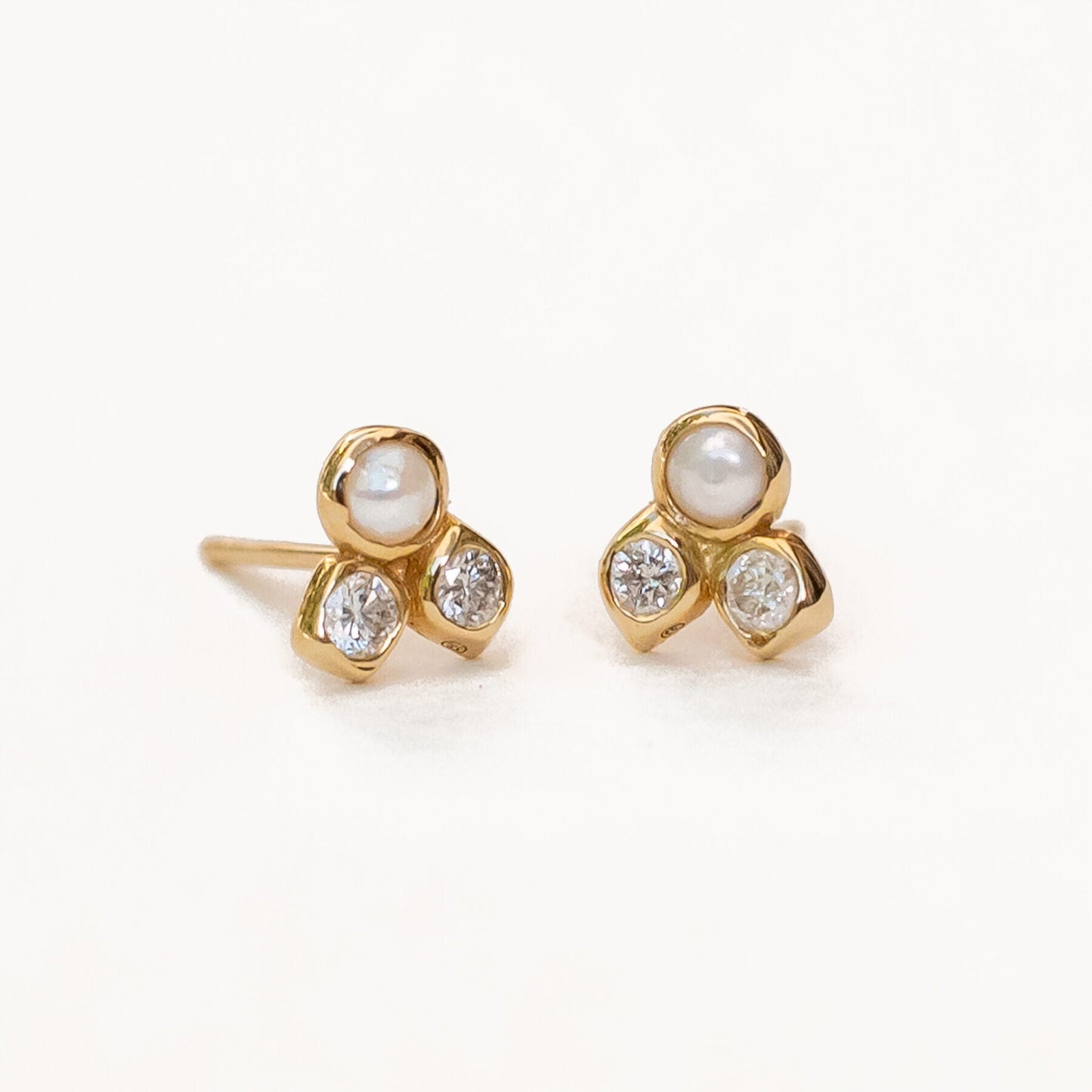 Side view of harmonia pearl and diamond studs demonstrating cluster setting detail