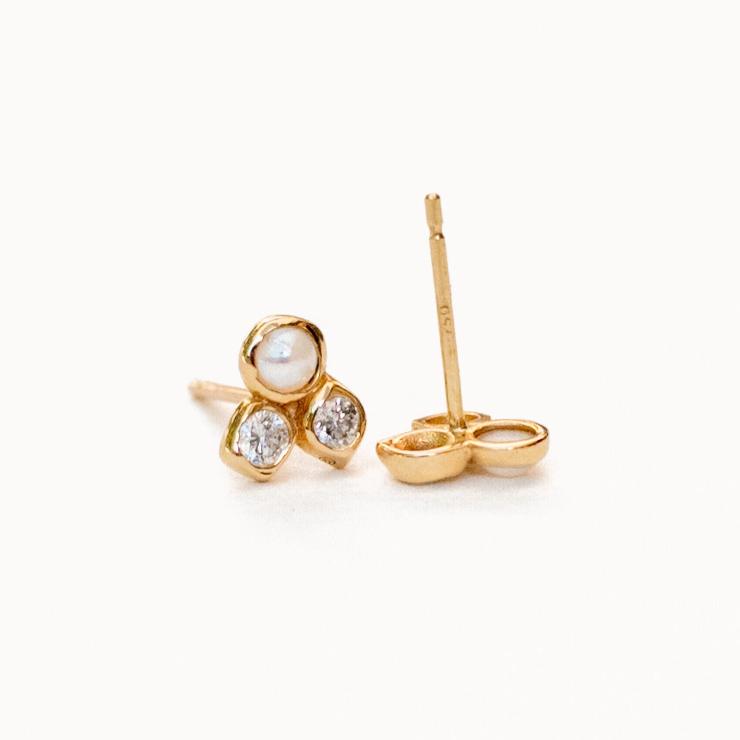 Model wearing harmonia pearl and diamond studs in formal setting
