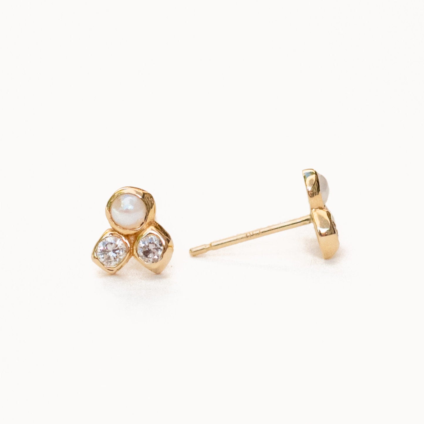 Hand detail showing harmonia cluster studs with natural pearl luminescence