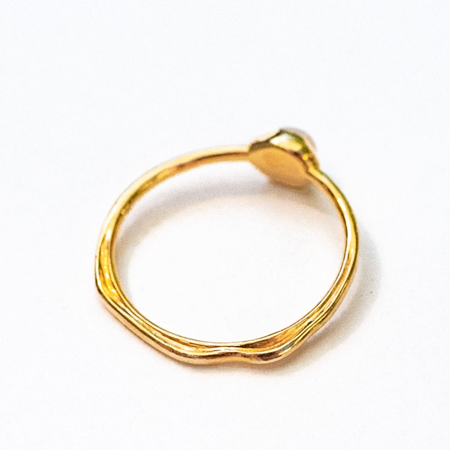Side profile of oceanus opal ring band showing sculptural form and stone setting