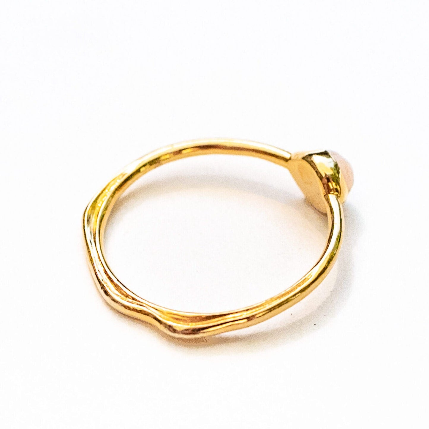 Model hand wearing 18K gold opal water line ring, lifestyle jewelry photography