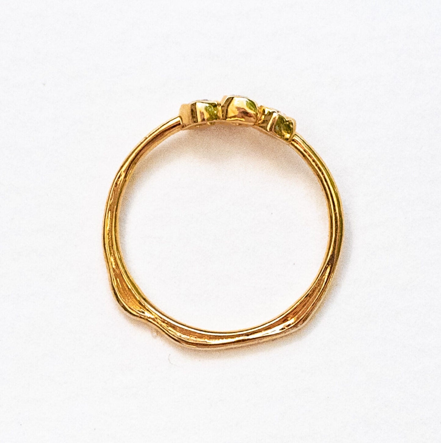 Three diamond cluster ring catching light, showing individual stone brilliance