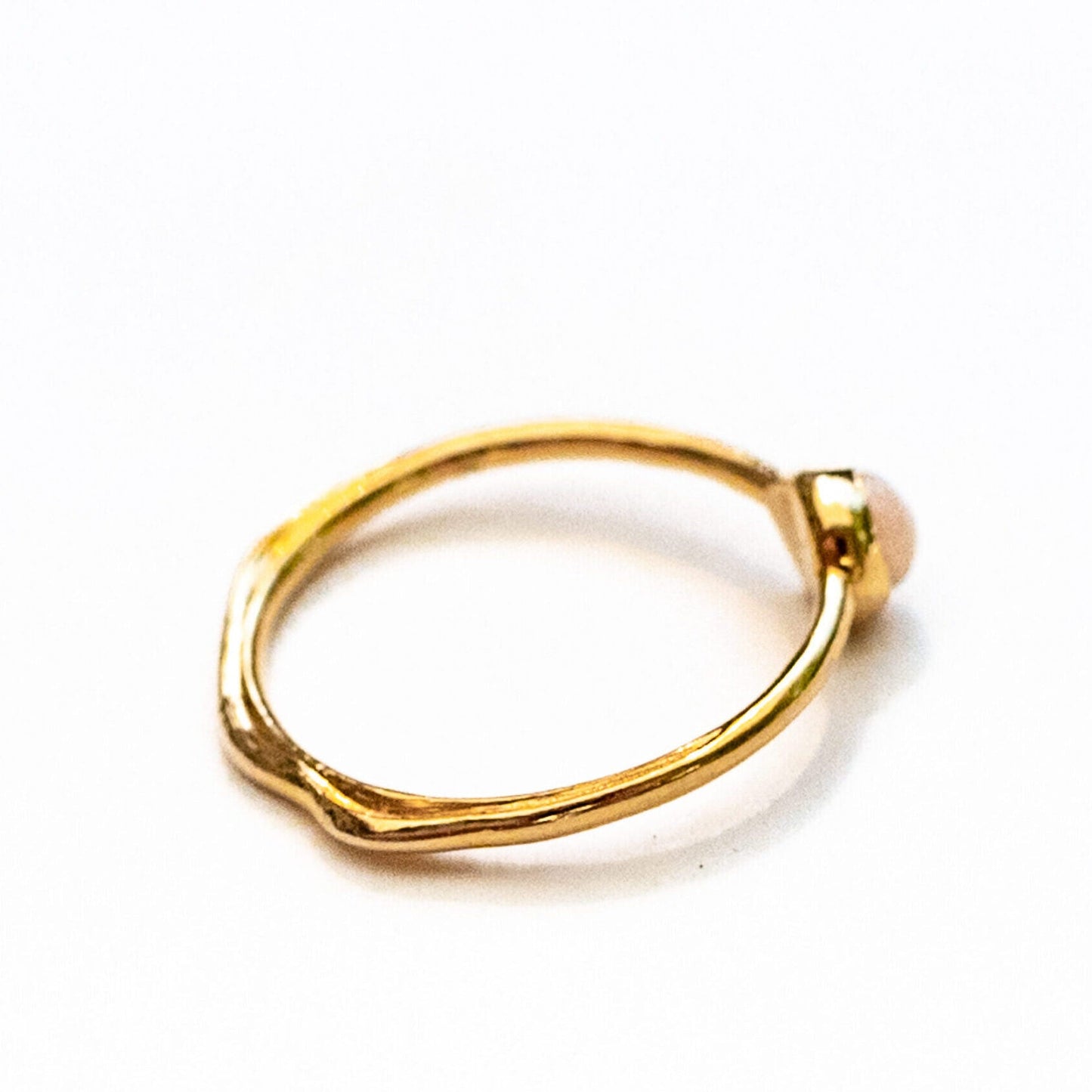 Overhead view of oceanus opal ring showing organic water line motif