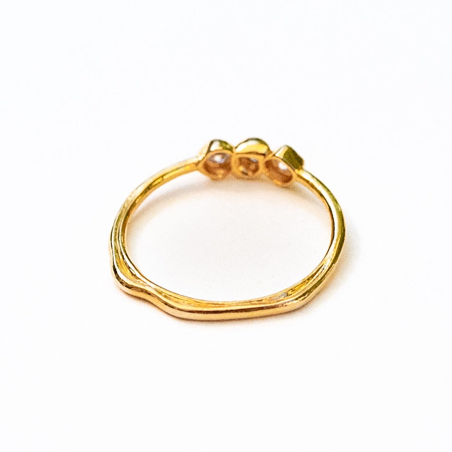 Detail of diamond settings in sea stone inspired formation on gold band