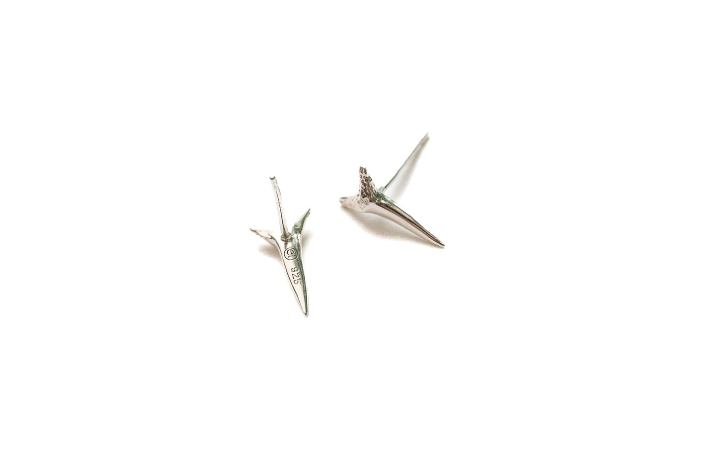 Model wearing silver shark tooth statement stud earrings