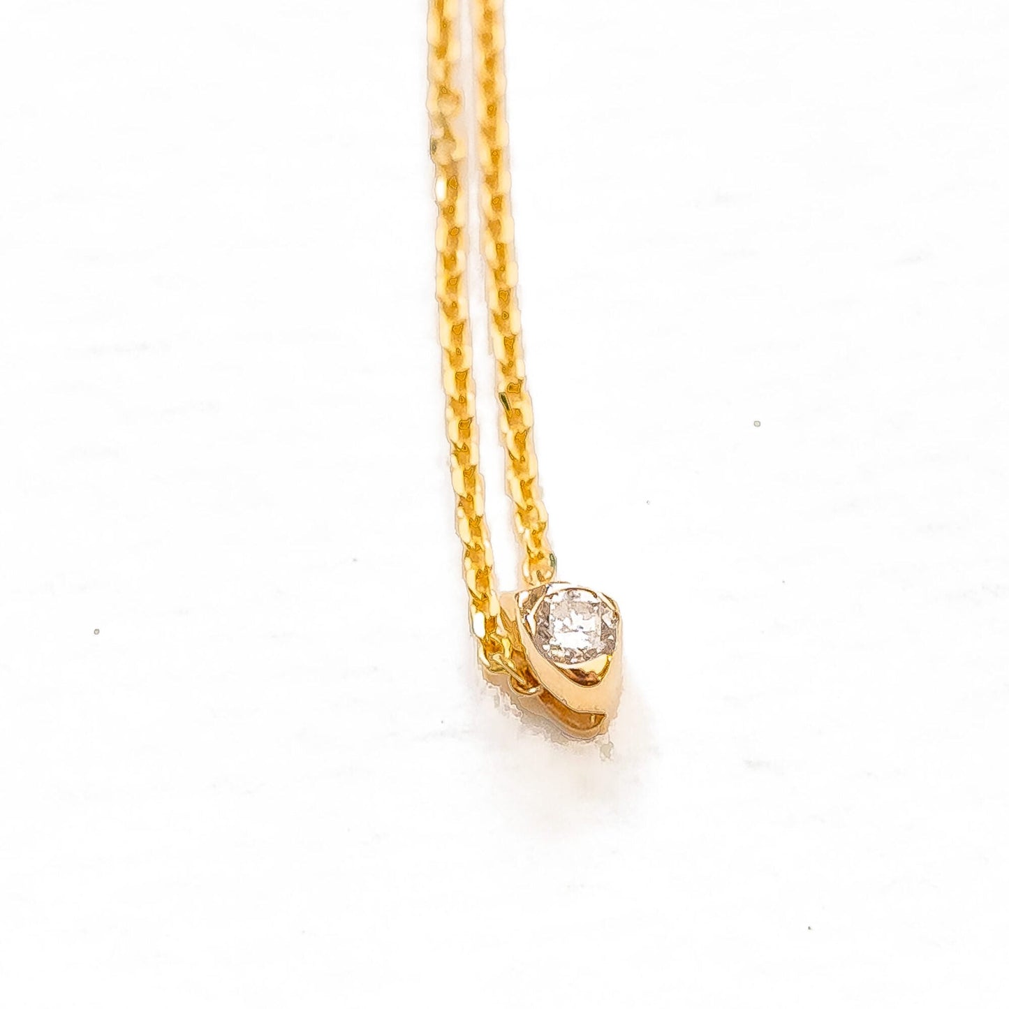 Side view of sea stone slide pendant demonstrating organic mounting form