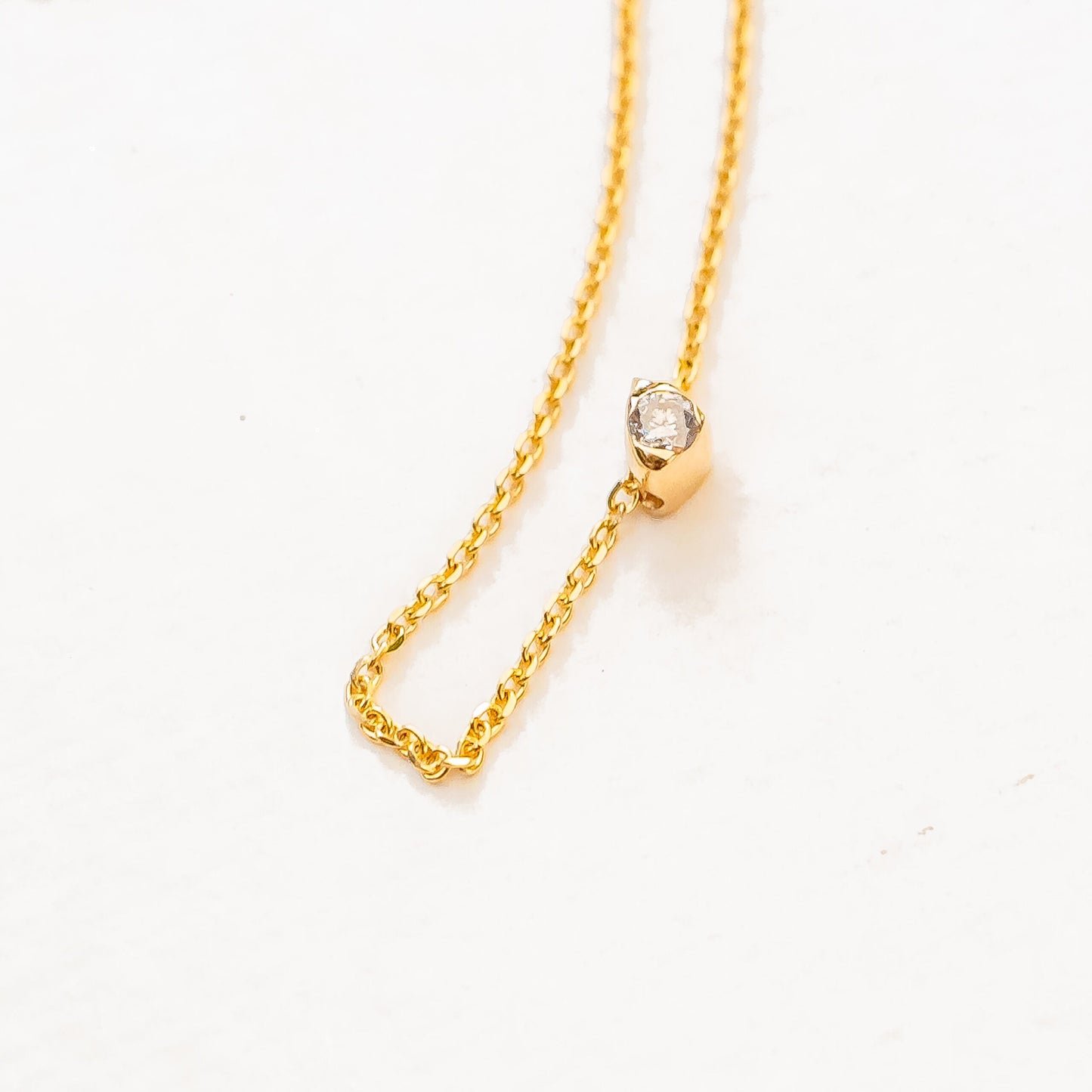 Model neck wearing sea stone diamond slide necklace as layering piece