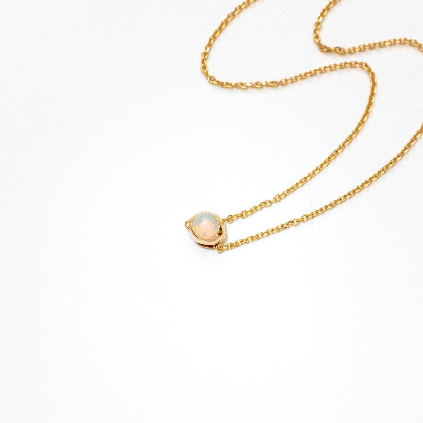 Overhead view of oceanus opal slide pendant with adjustable mechanism