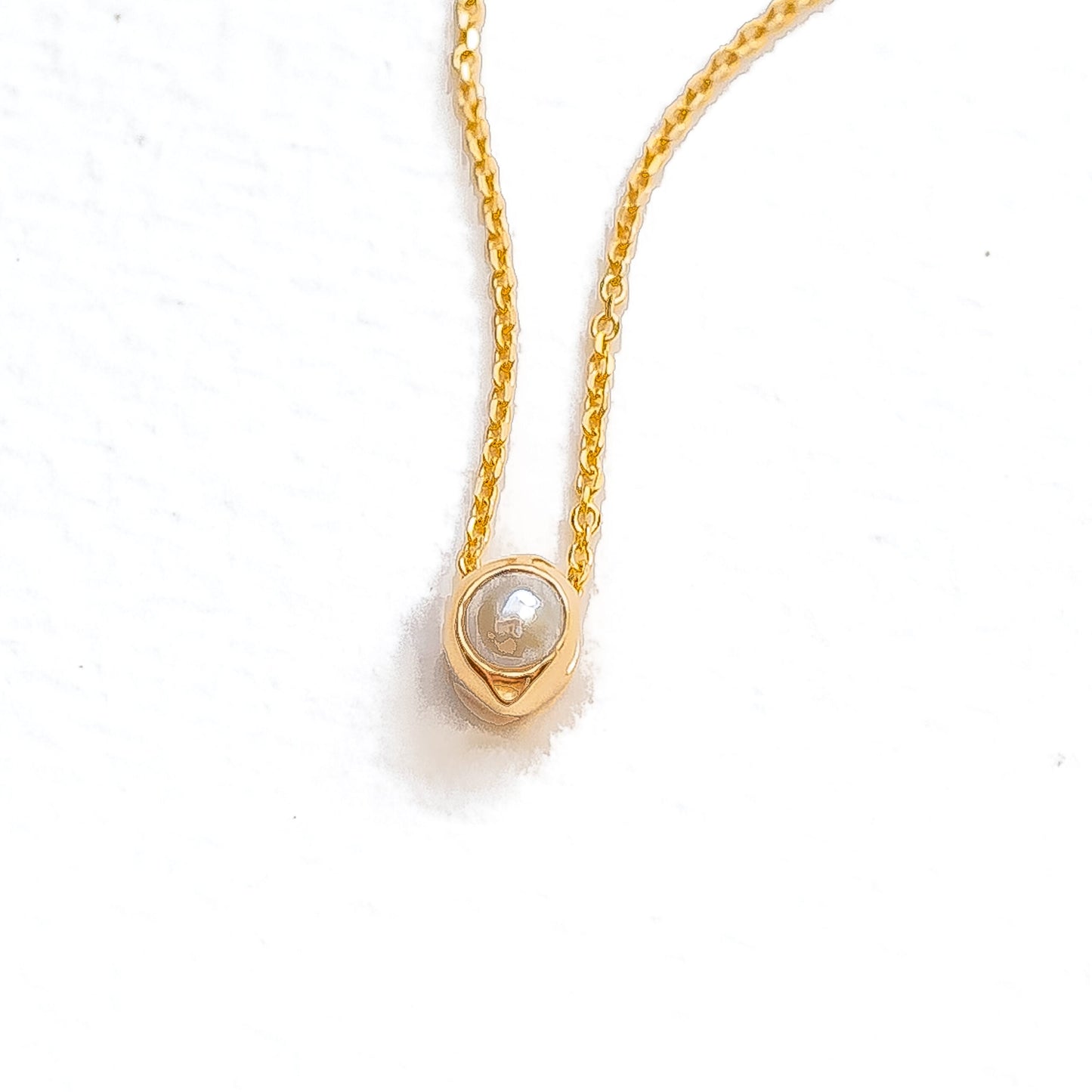 Close-up of oceanus pearl showing natural luminescence and cabochon setting