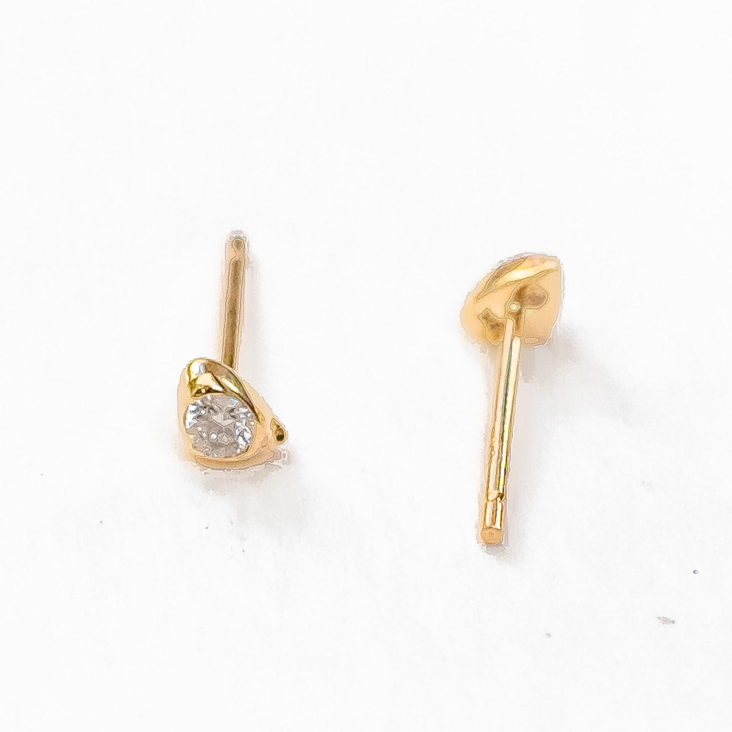 Overhead view of pair of sea stone diamond studs showing symmetrical placement