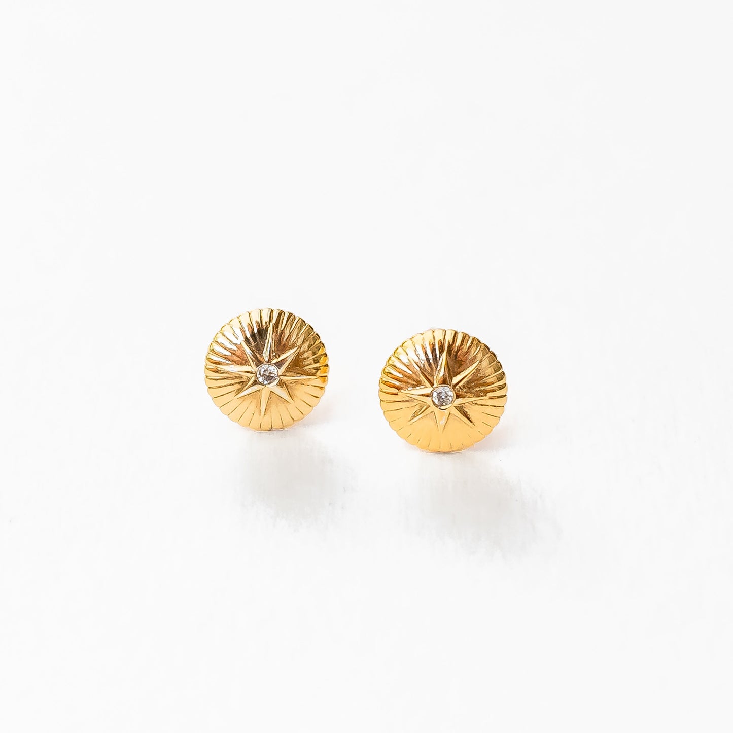 Overhead view of pair of 18K gold nova diamond studs